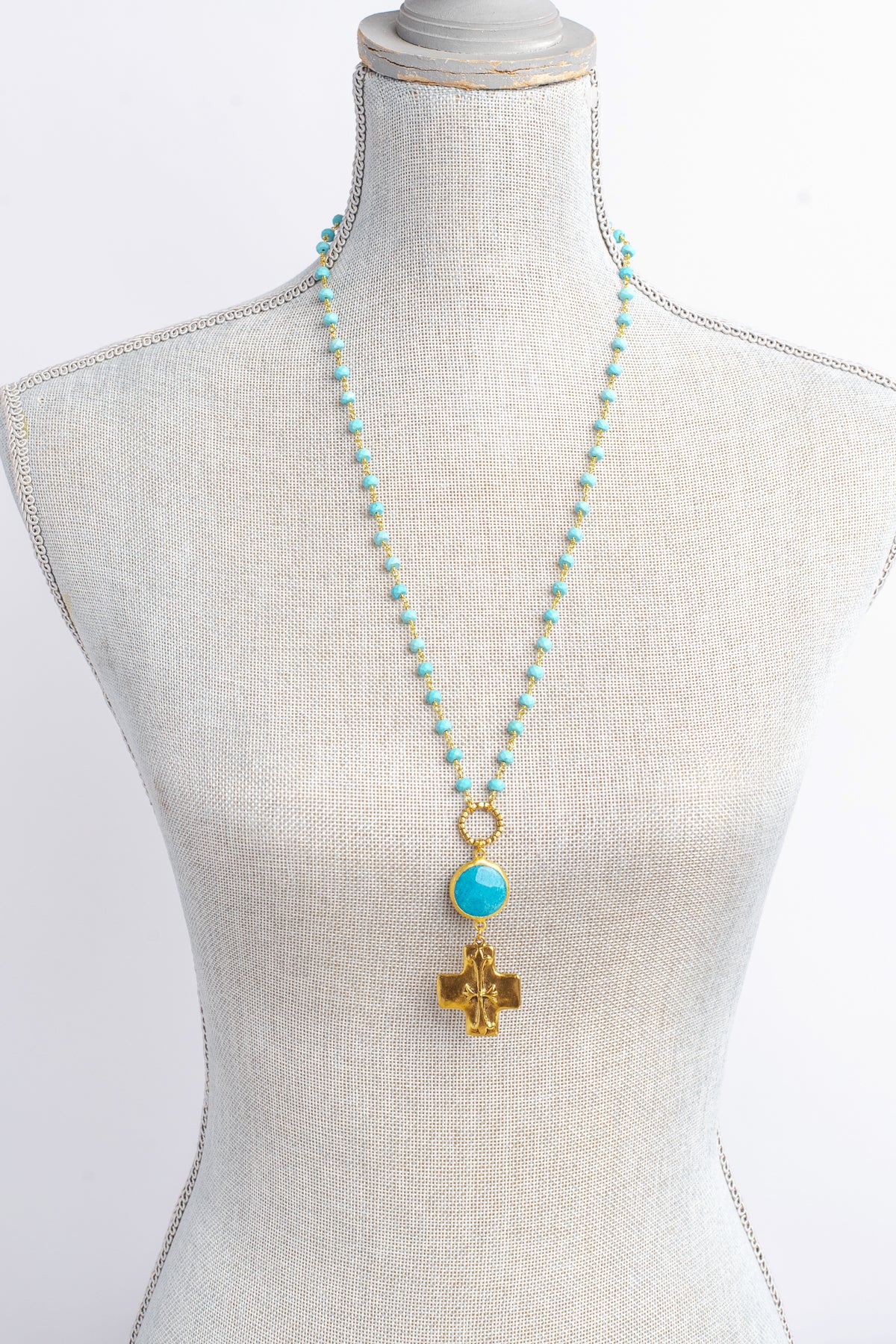 Gold Cross Pendant on a Blue Turquoise Stone Beaded Necklace
