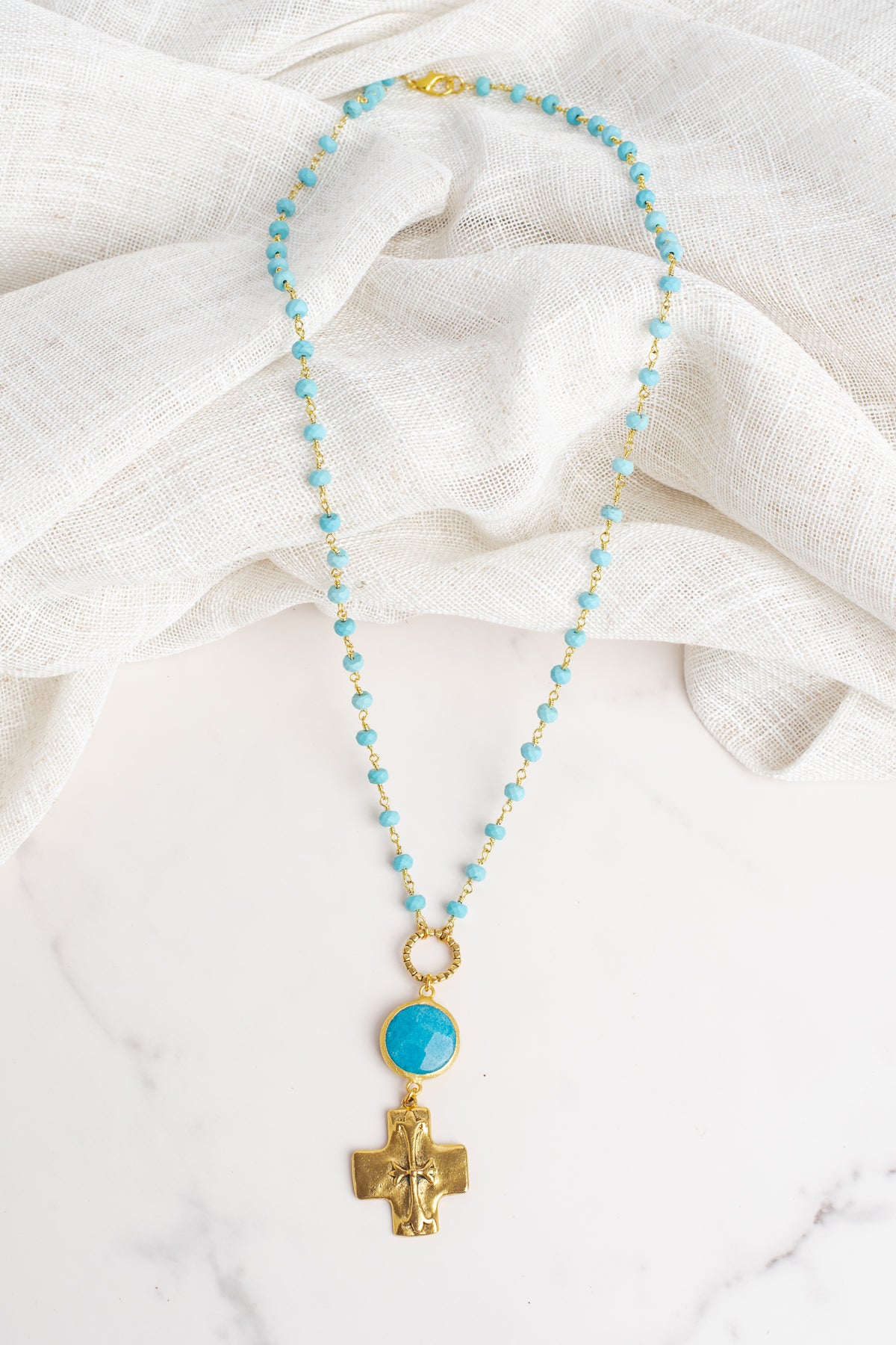 Gold Cross Pendant on a Blue Turquoise Stone Beaded Necklace