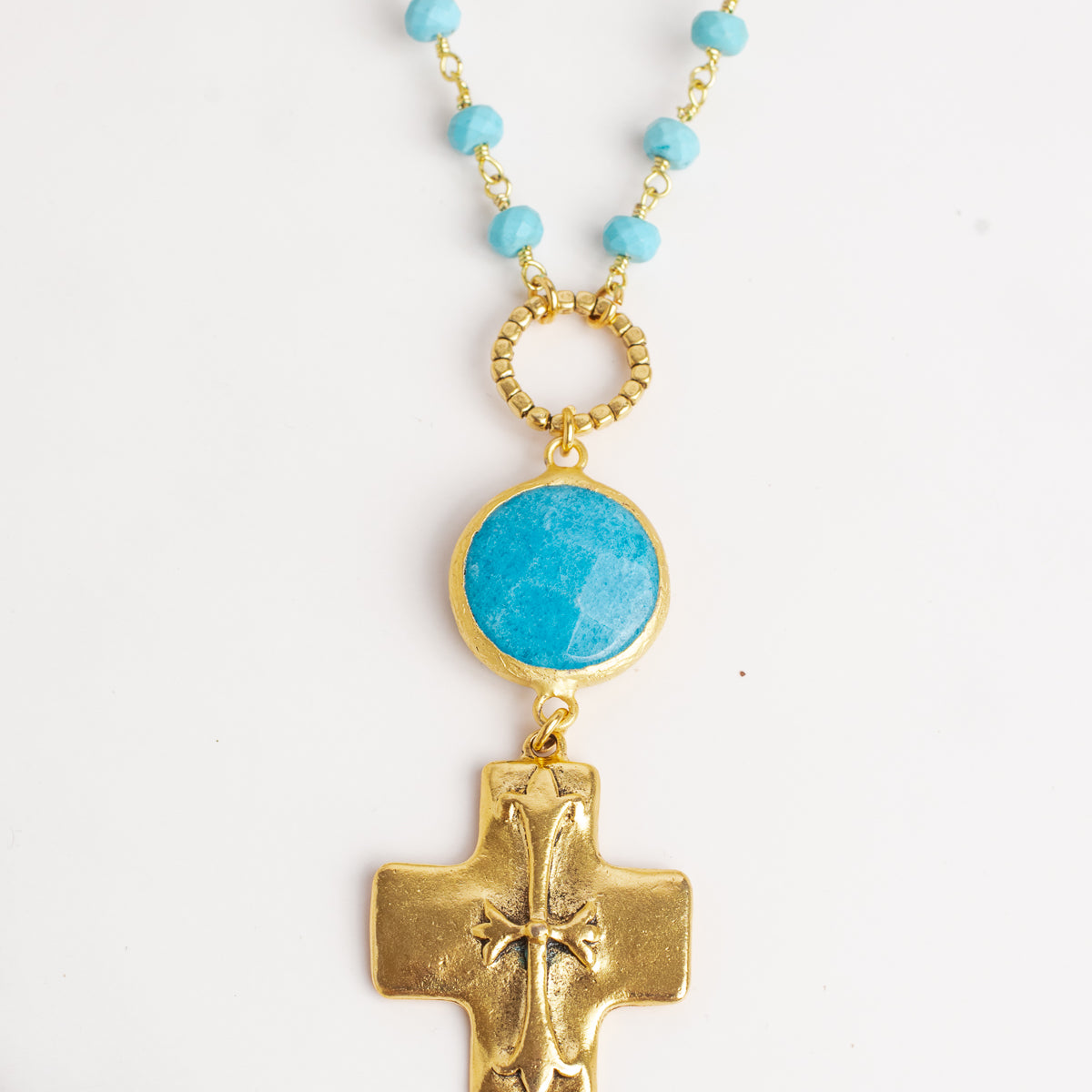 Gold Cross Pendant on a Blue Turquoise Stone Beaded Necklace