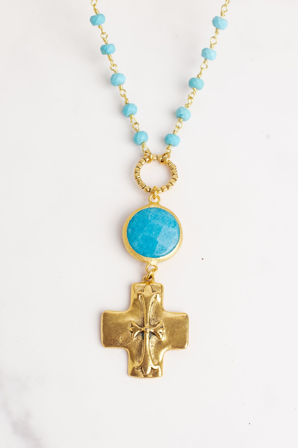 Gold Cross Pendant on a Blue Turquoise Stone Beaded Necklace