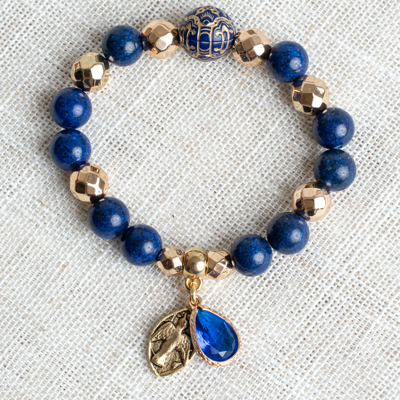 Royal Blue Lapis and Gold plated Hemitite Beaded Stretch Bracelet with Gold Plated Cross Charm and Crystal