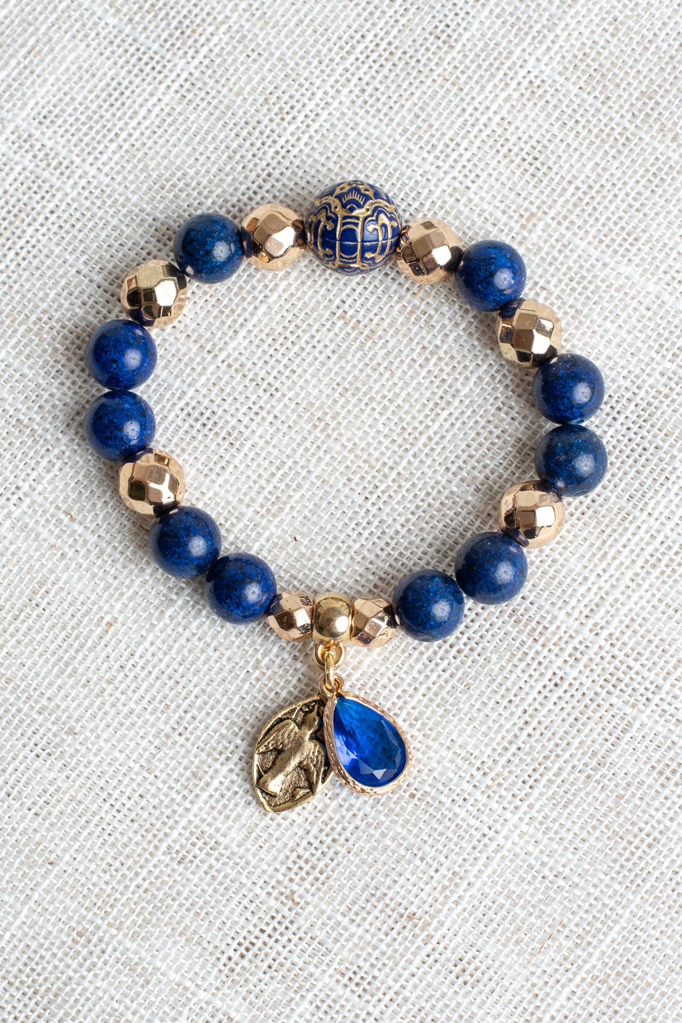 Royal Blue Lapis and Gold plated Hemitite Beaded Stretch Bracelet with Gold Plated Cross Charm and Crystal