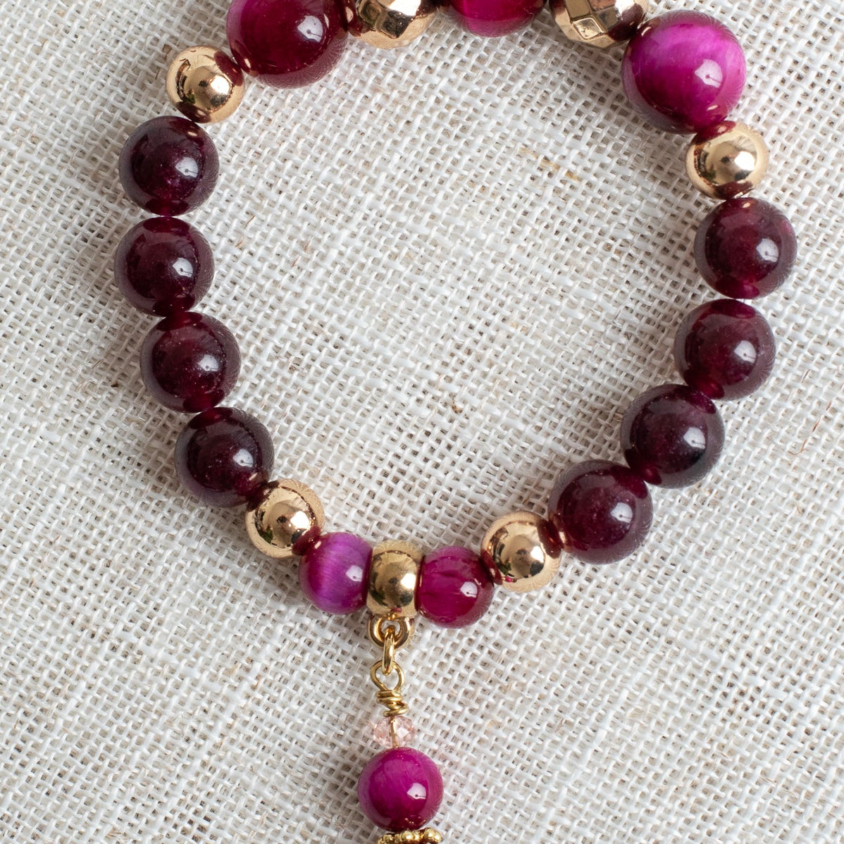 Magenta Tiger's Eye Jasper and Garnet Stone Beads with Gold Plated Elements on a Stretch Bracelet with Matching Beaded Charm