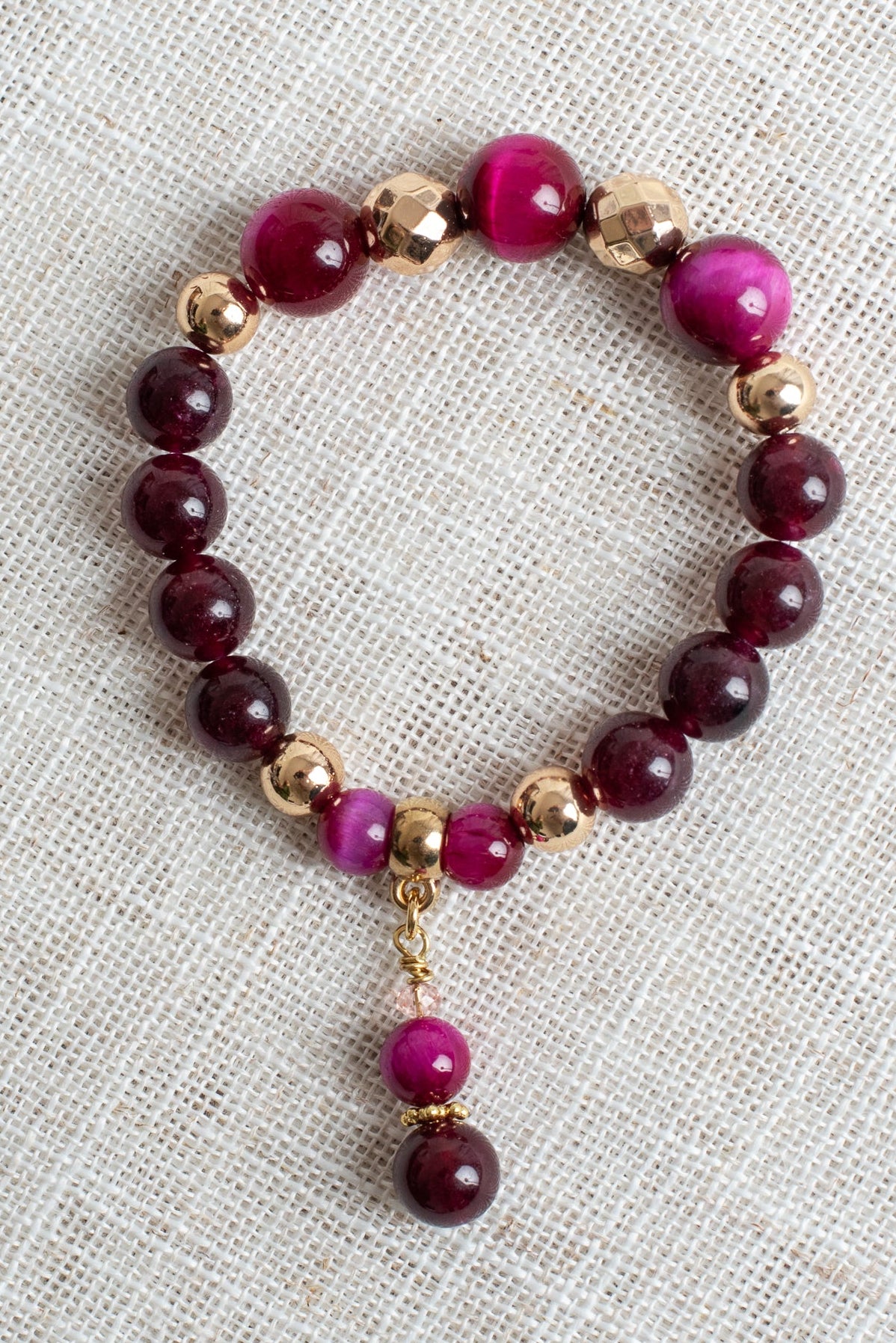Magenta Tiger's Eye Jasper and Garnet Stone Beads with Gold Plated Elements on a Stretch Bracelet with Matching Beaded Charm
