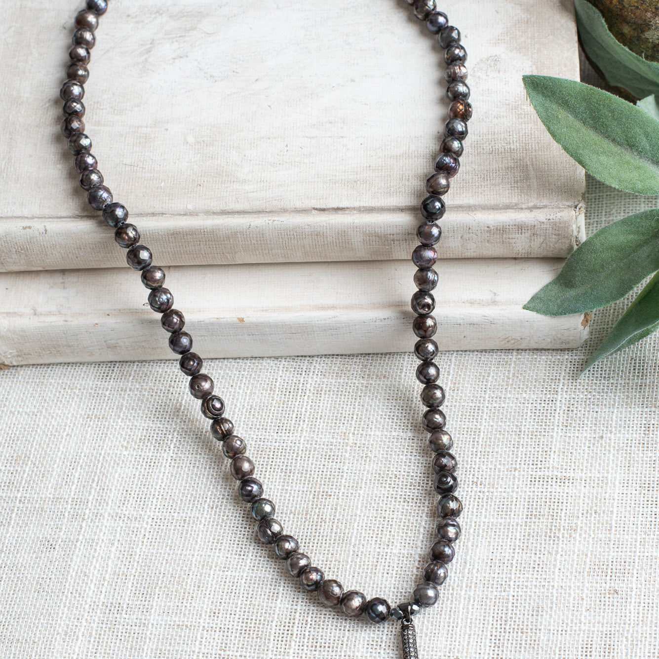 Gunmetal Sterling Silver Micro Pave Modern Cross Pendant on a Faceted Peacock Pearl Strand