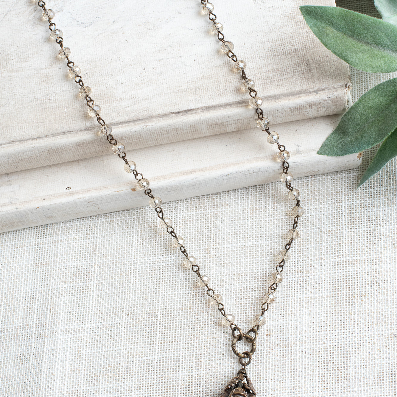 Bronze Vintage Floral and Clear Quartz Pendant on a Light Tan Crystal and Bronze Rosary Chain Necklace