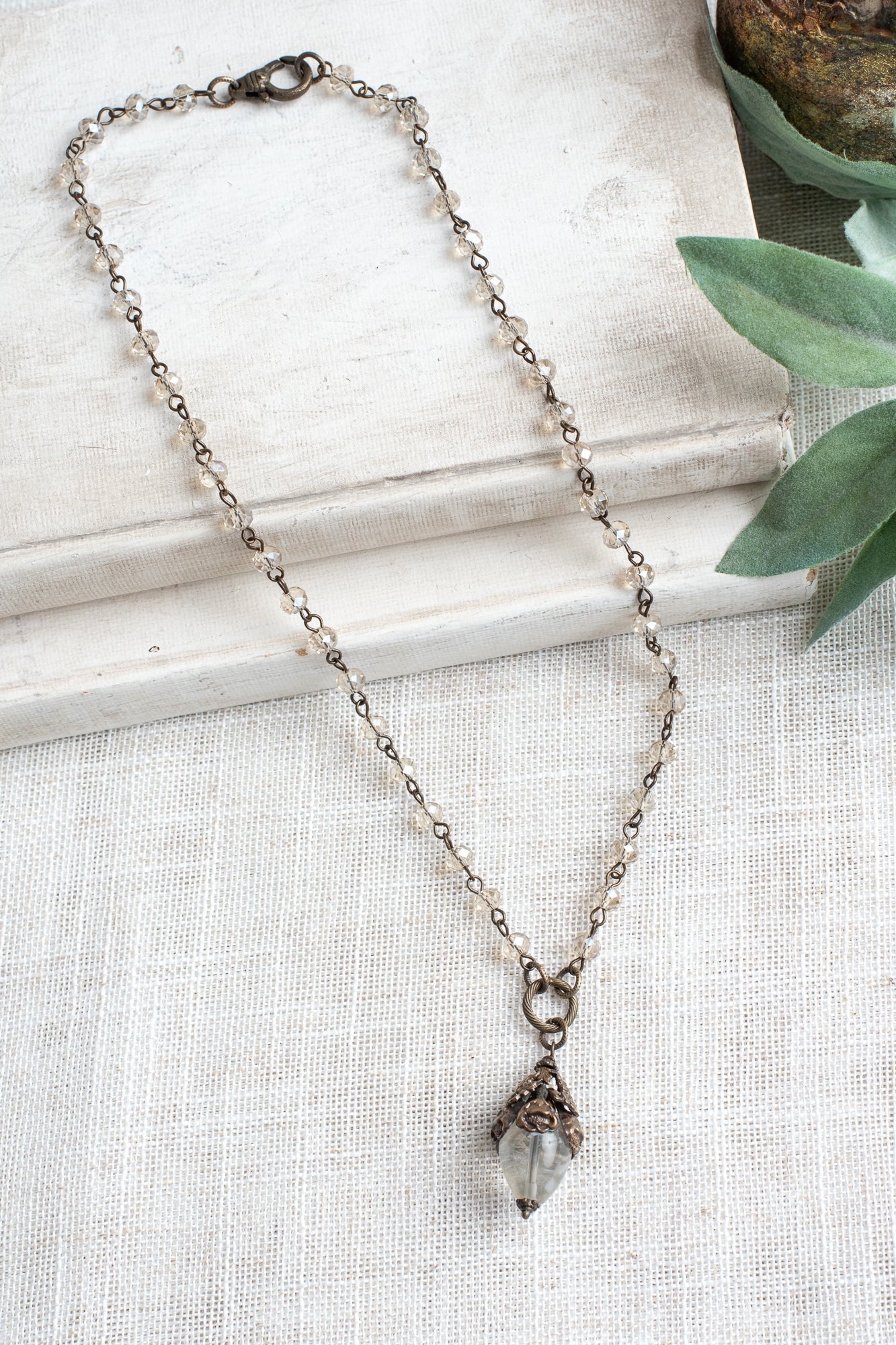 Bronze Vintage Floral and Clear Quartz Pendant on a Light Tan Crystal and Bronze Rosary Chain Necklace