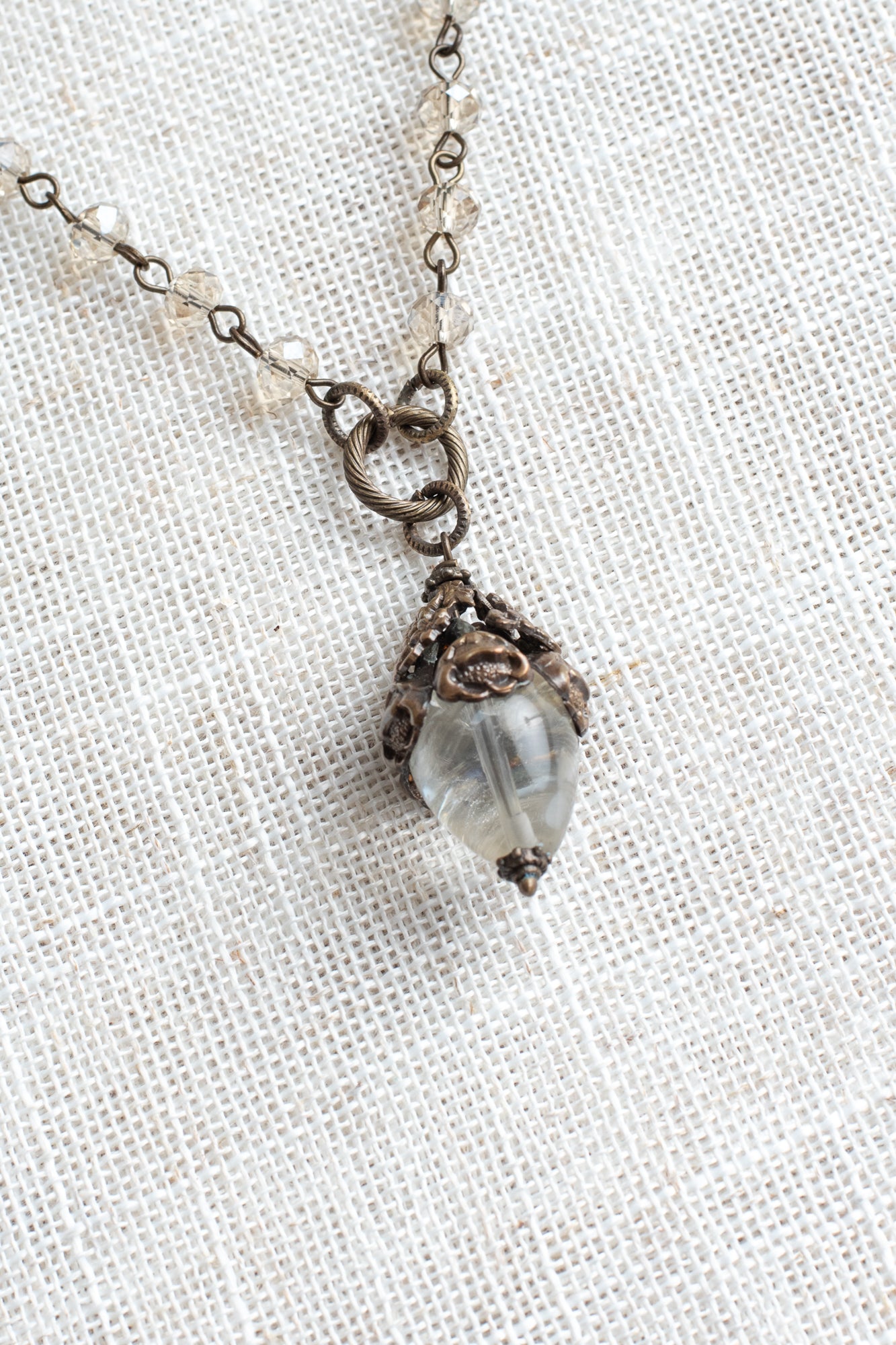 Bronze Vintage Floral and Clear Quartz Pendant on a Light Tan Crystal and Bronze Rosary Chain Necklace