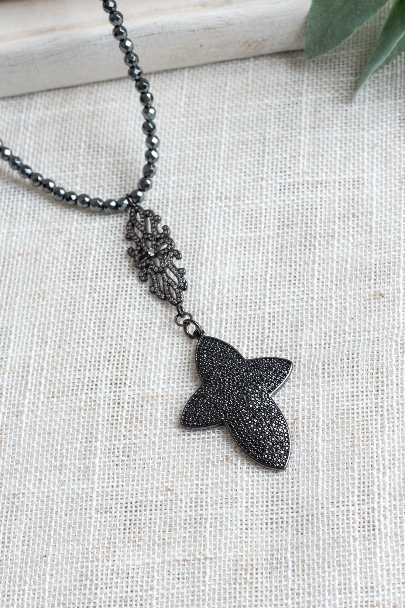Pavé Black Crystal Cross Pendant on a Faceted Pyrite Beaded Necklace