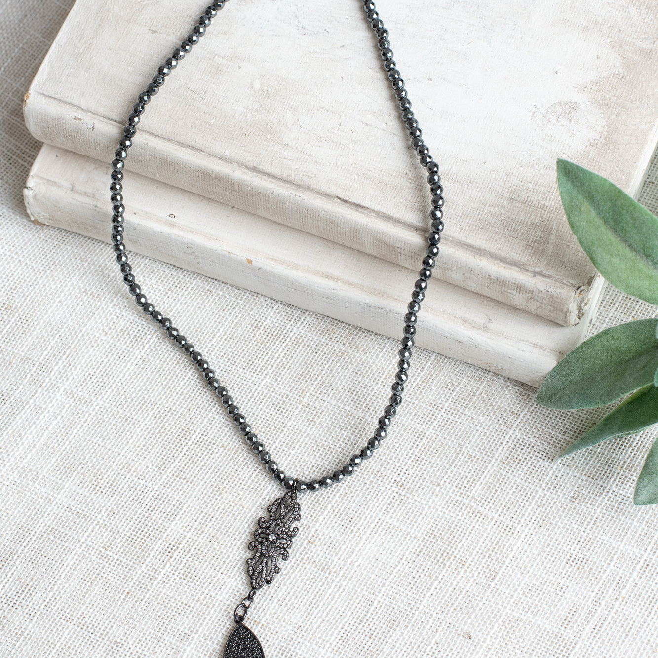 Pavé Black Crystal Cross Pendant on a Faceted Pyrite Beaded Necklace