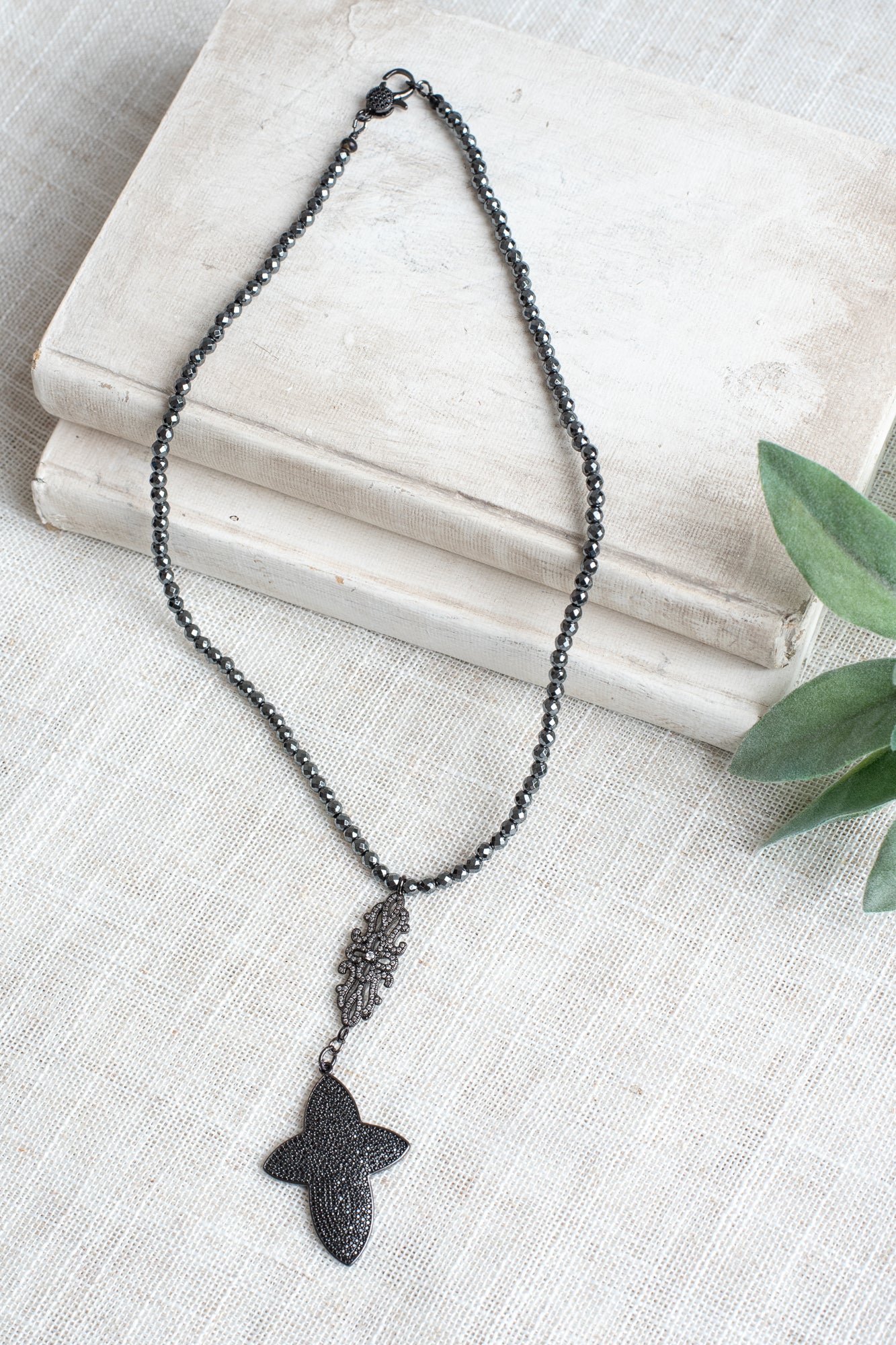 Pavé Black Crystal Cross Pendant on a Faceted Pyrite Beaded Necklace