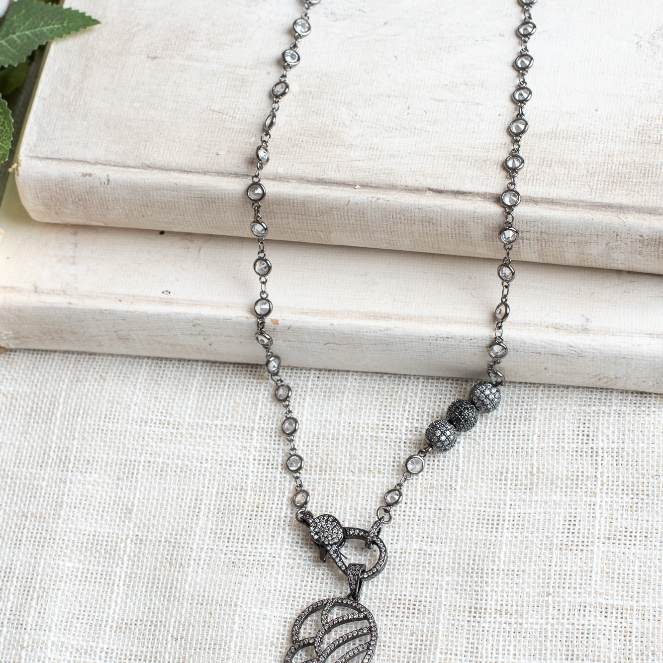 Black Micro Pave Angel Wing Pendant on a White Crystal Gunmeal Station Chain Necklace