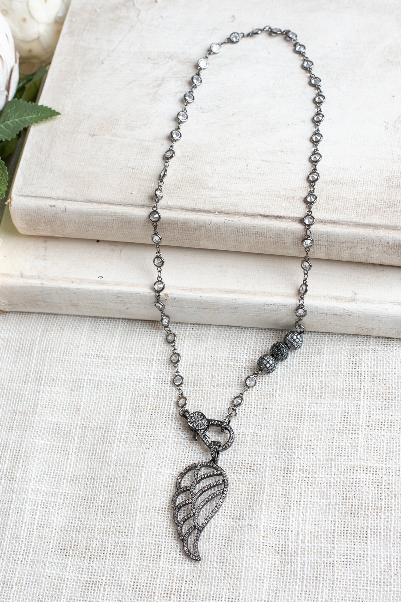 Black Micro Pave Angel Wing Pendant on a White Crystal Gunmeal Station Chain Necklace