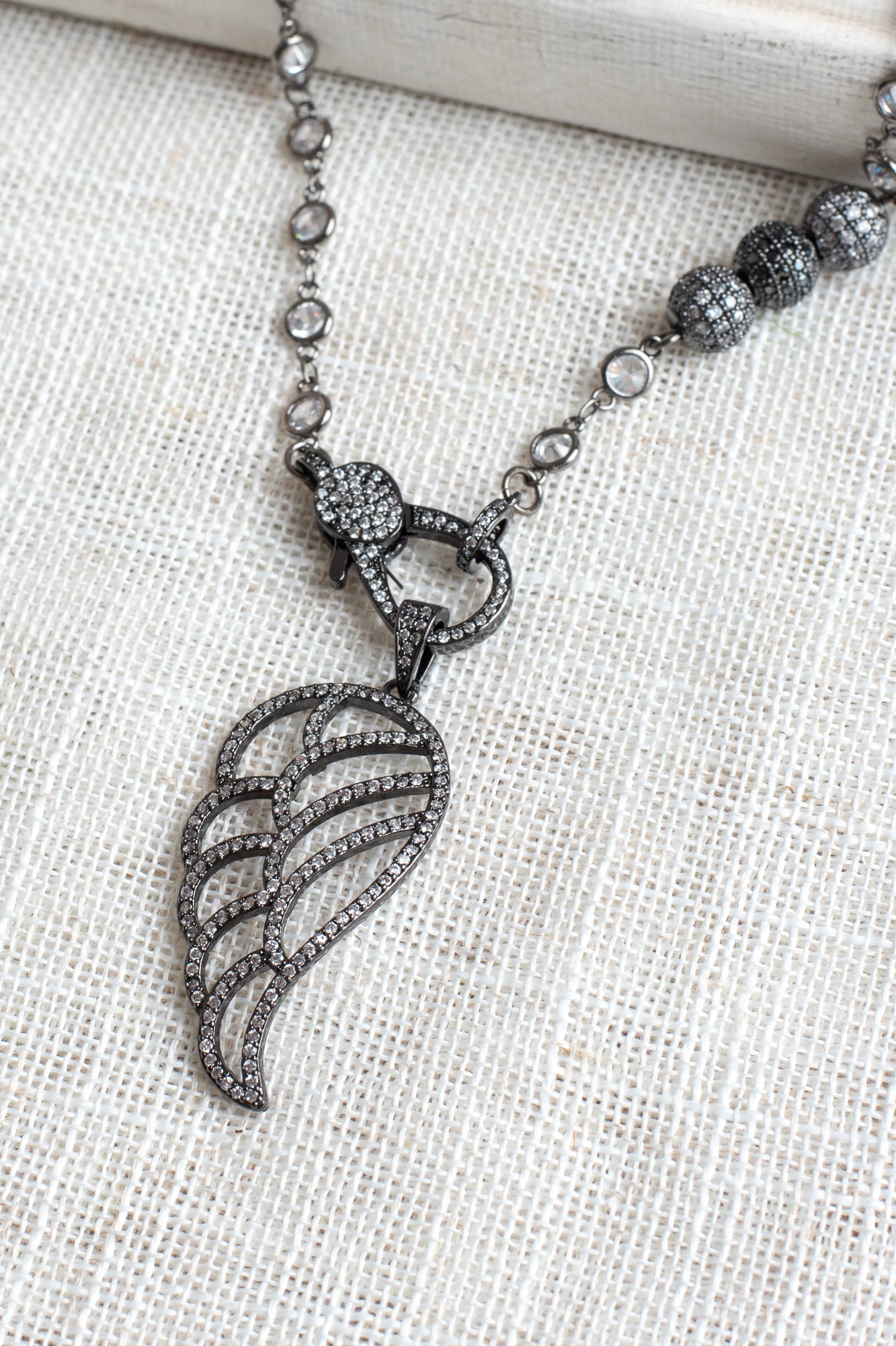 Black Micro Pave Angel Wing Pendant on a White Crystal Gunmeal Station Chain Necklace