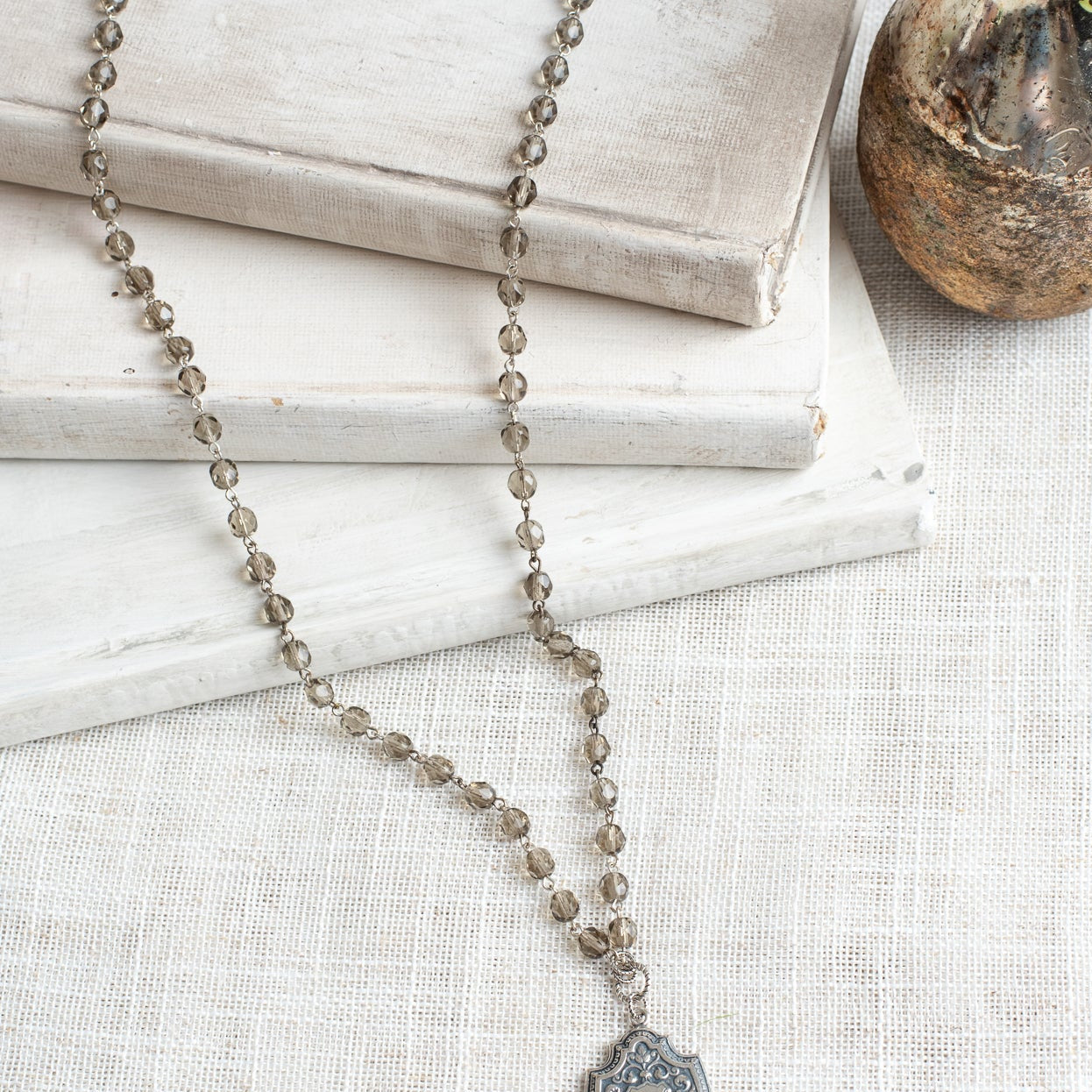 Sterling Silver Cherub and Vintage Style Silver Plated Shield Filigree Pendant on a Taupe Crystal and Silver Rosary Chain Necklace