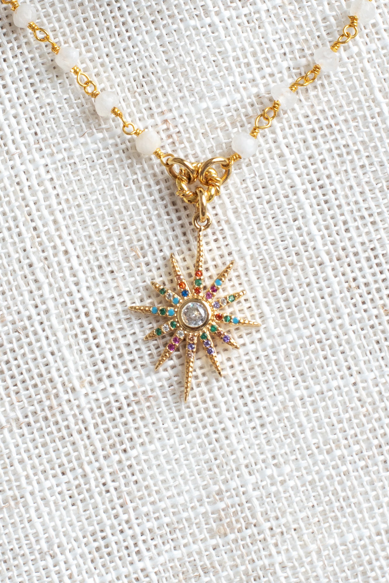 Delicate Gold Starburst Pendant on a Moonstone and Gold Plated Rosary Chain Necklace