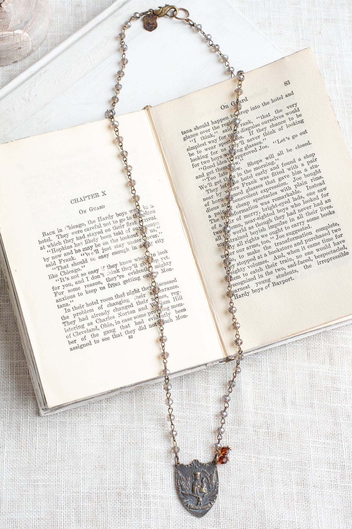 Prague Madonna and Child Catholic Bronze Shield Pendant on a Gray Crystal Rosary Chain Necklace