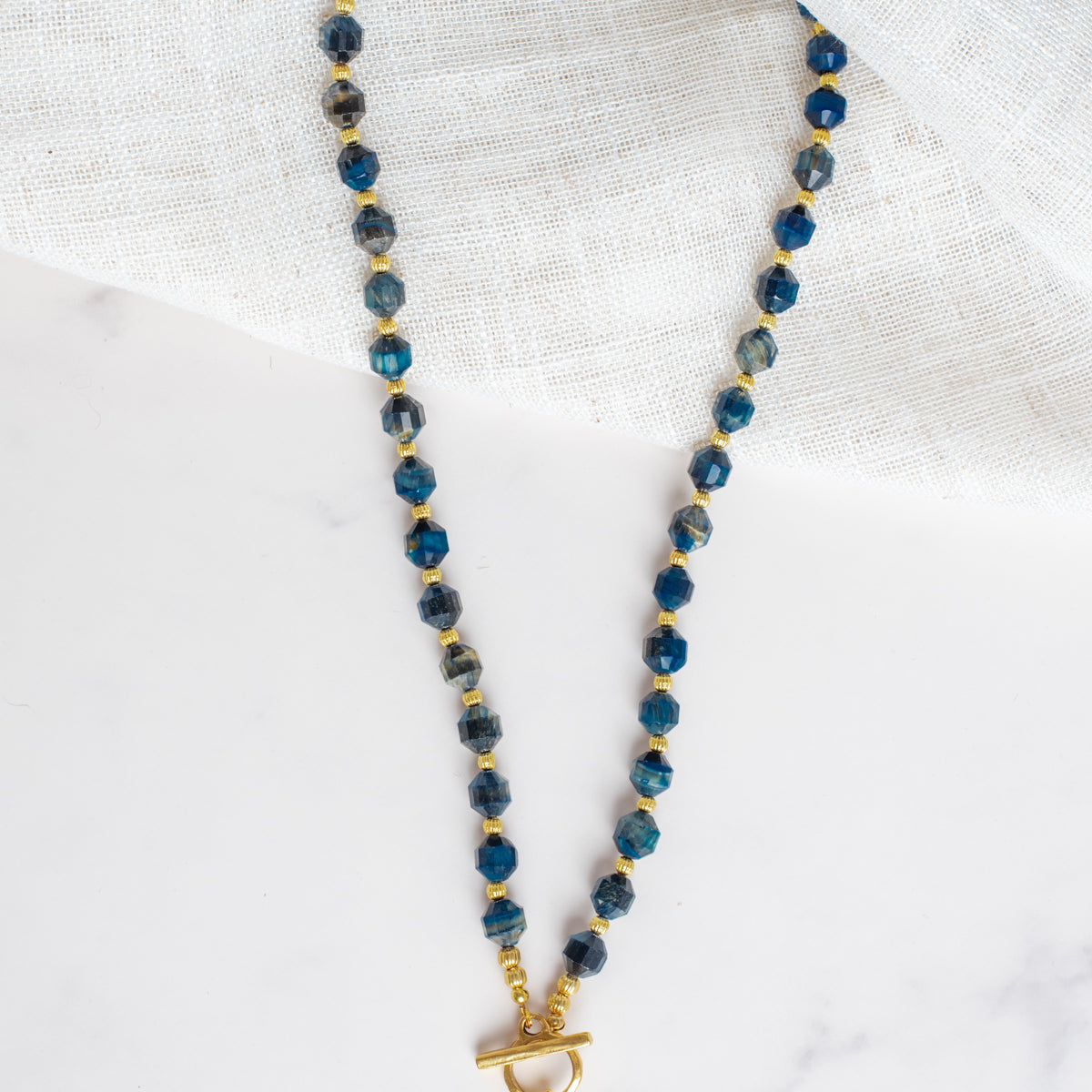 Gold Cross Pendant on a Blue Cat's Eye Stone Beaded Necklace