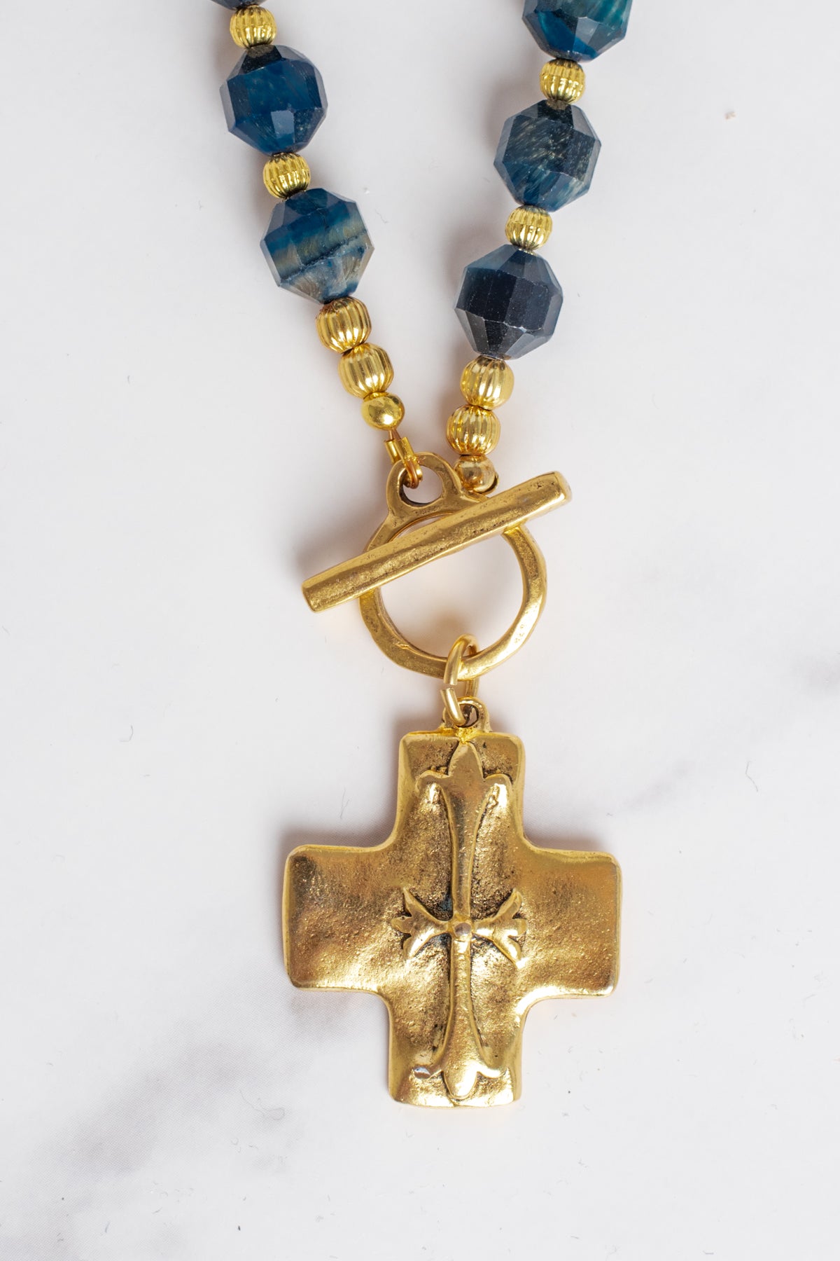 Gold Cross Pendant on a Blue Cat's Eye Stone Beaded Necklace