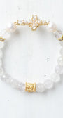 Faceted White Quartz Crystal Beaded Stretch Bracelet with a Wrist Cross Charm in Pearl and Crystal with Gold Plating.