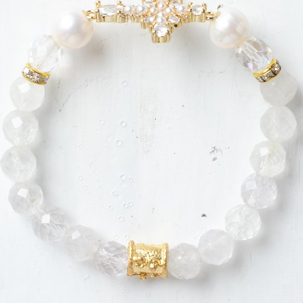 Faceted White Quartz Crystal Beaded Stretch Bracelet with a Wrist Cross Charm in Pearl and Crystal with Gold Plating.