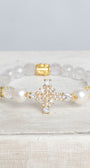Faceted White Quartz Crystal Beaded Stretch Bracelet with a Wrist Cross Charm in Pearl and Crystal with Gold Plating.