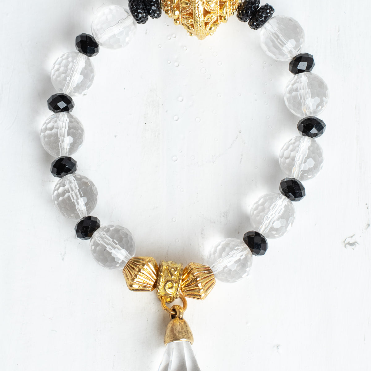 Crystal Quartz Faceted Beads with Gold Filigree Focal on a Stretch Bracelet with a Crystal Drop Charm