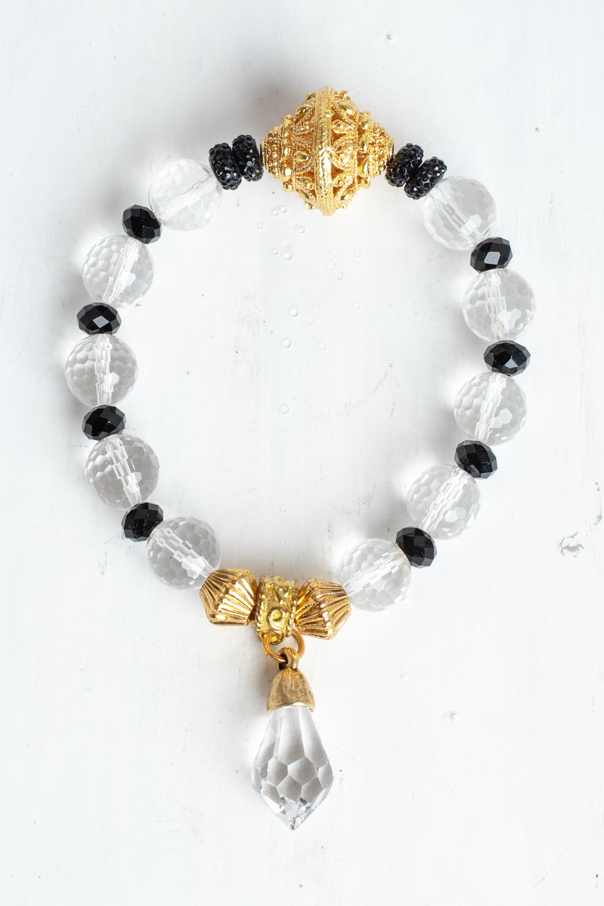 Crystal Quartz Faceted Beads with Gold Filigree Focal on a Stretch Bracelet with a Crystal Drop Charm