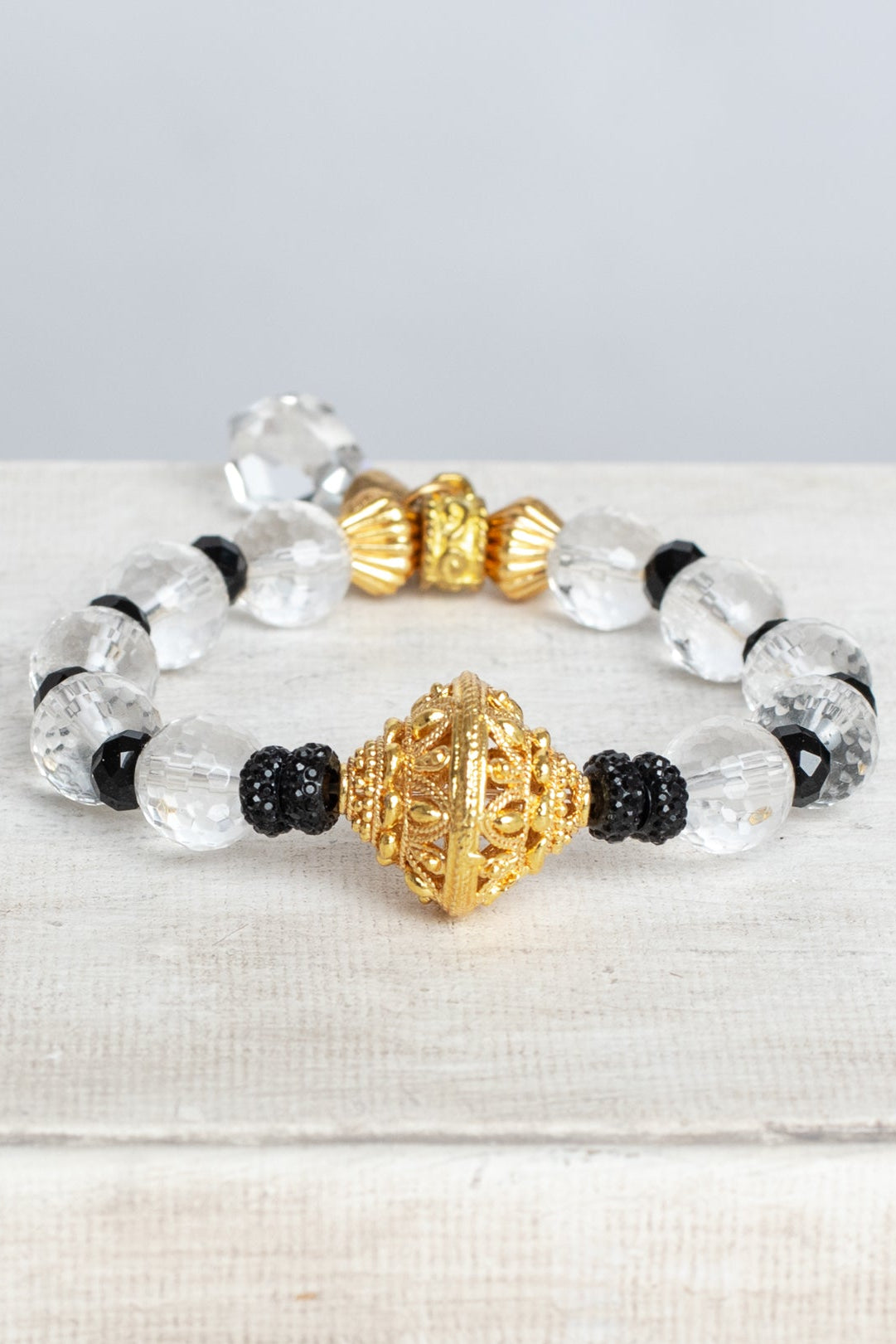 Crystal Quartz Faceted Beads with Gold Filigree Focal on a Stretch Bracelet with a Crystal Drop Charm
