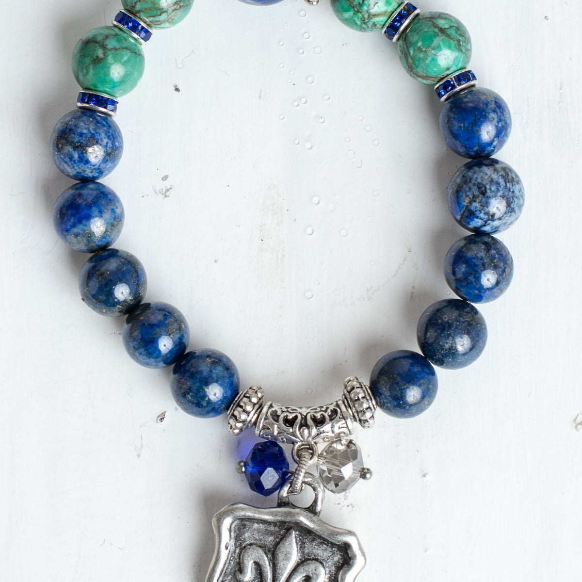Blue Sodalite and Green Turquoise Stone Bead Stretch Bracelet with Silver Fleur de Lis Shield Charm