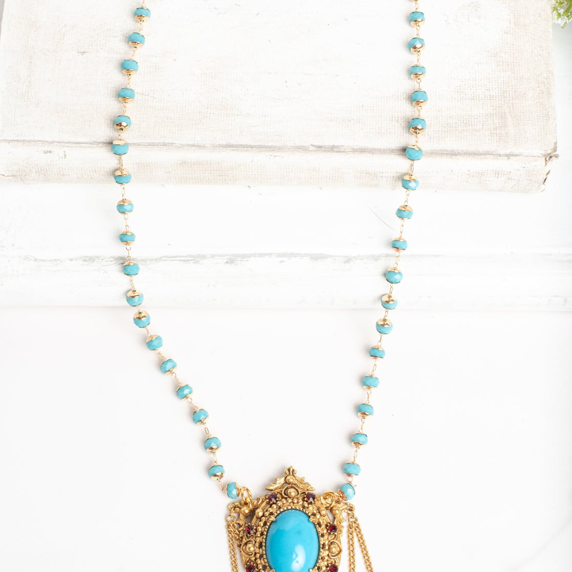 Vintage Gold Plated Florenza Collectible Pendant with Red Rhinestones, Faux Turquoise Cabachon and Chain Draping on a Turquoise and Gold Rosary Chain Necklace