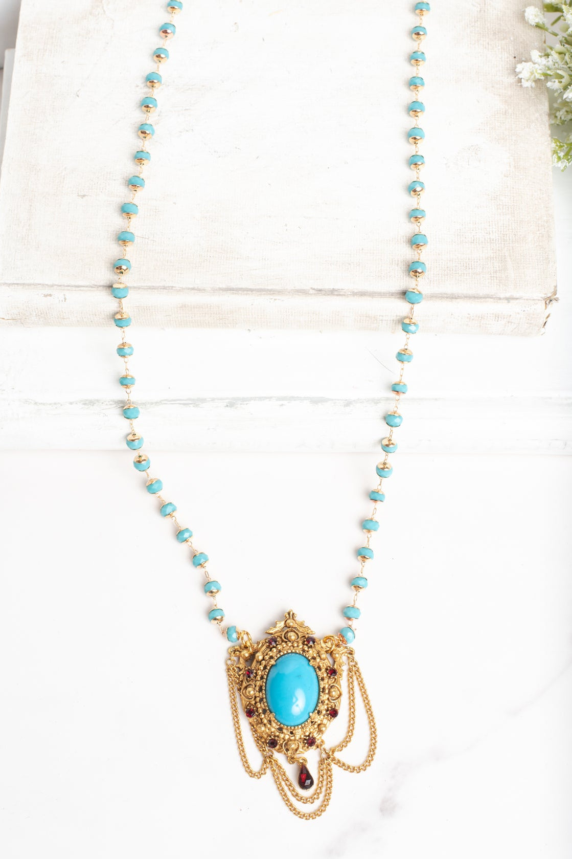 Vintage Gold Plated Florenza Collectible Pendant with Red Rhinestones, Faux Turquoise Cabachon and Chain Draping on a Turquoise and Gold Rosary Chain Necklace