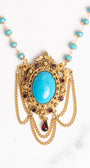 Vintage Gold Plated Florenza Collectible Pendant with Red Rhinestones, Faux Turquoise Cabachon and Chain Draping on a Turquoise and Gold Rosary Chain Necklace