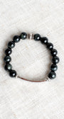 Silver Center Plate with LOVE in Crytal Letters on Black Obsidian Beads with Hints of Gray Stretch Bracelet