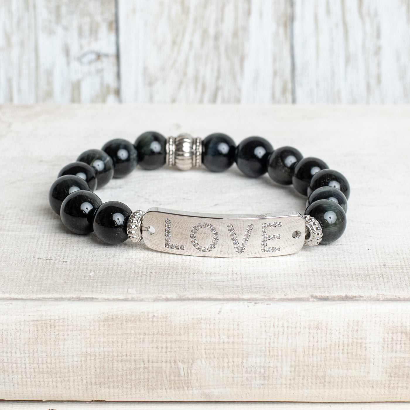 Silver Center Plate with LOVE in Crytal Letters on Black Obsidian Beads with Hints of Gray Stretch Bracelet