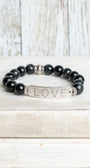 Silver Center Plate with LOVE in Crytal Letters on Black Obsidian Beads with Hints of Gray Stretch Bracelet