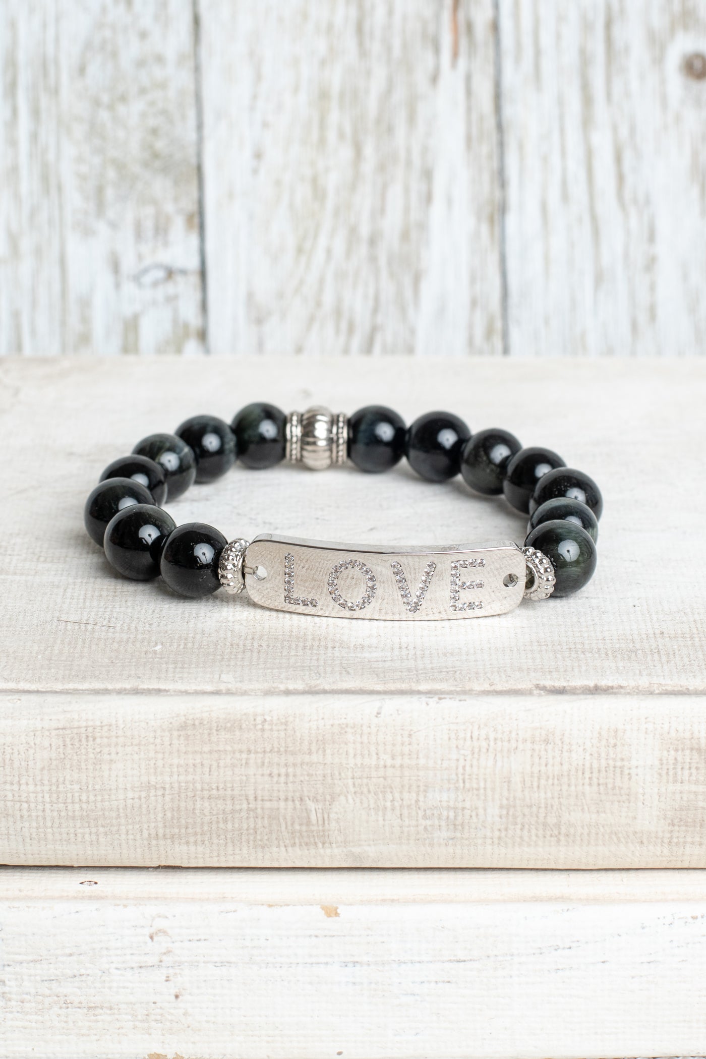 Silver Center Plate with LOVE in Crytal Letters on Black Obsidian Beads with Hints of Gray Stretch Bracelet