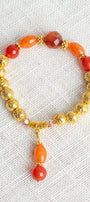Carnelian and Orange Quartz Stone Beads with 14K Gold Plated Lava Stone Beads on a Stretch Bracelet with Beaded Charm