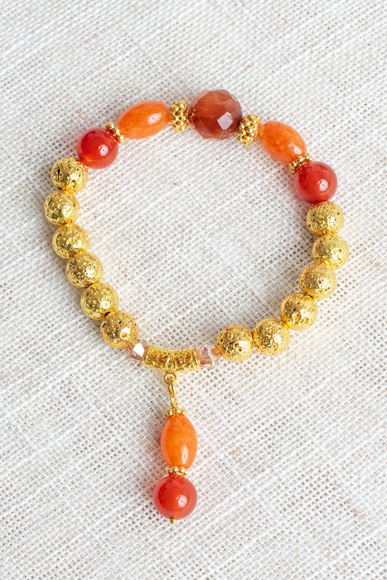 Carnelian and Orange Quartz Stone Beads with 14K Gold Plated Lava Stone Beads on a Stretch Bracelet with Beaded Charm
