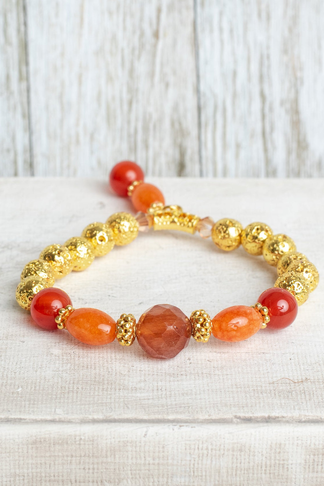 Carnelian and Orange Quartz Stone Beads with 14K Gold Plated Lava Stone Beads on a Stretch Bracelet with Beaded Charm