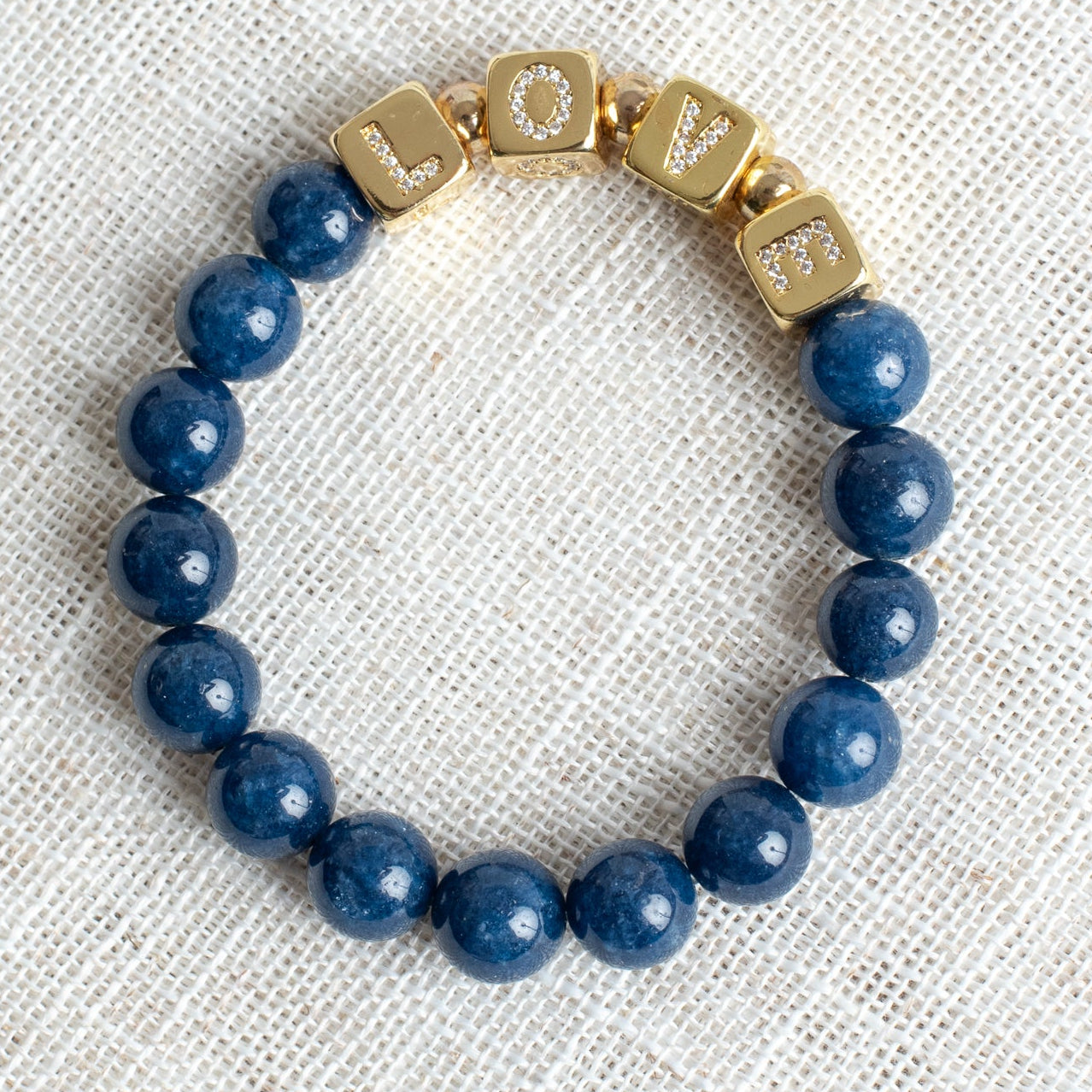 Striking Gold Plated Cube Beads with Pave Crystal Letters Spelling LOVE on Navy Blue Agate Stretch Bracelet