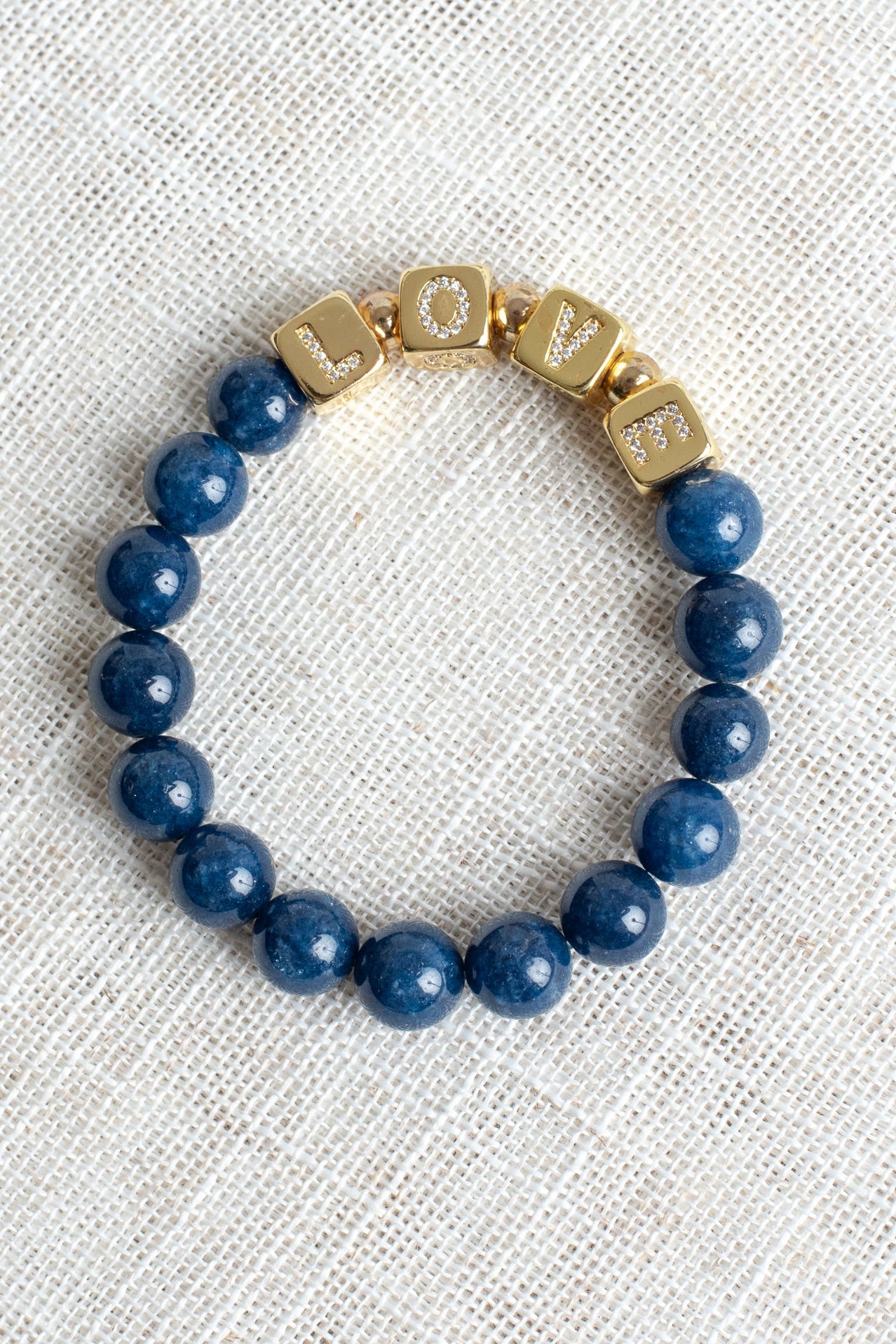 Striking Gold Plated Cube Beads with Pave Crystal Letters Spelling LOVE on Navy Blue Agate Stretch Bracelet