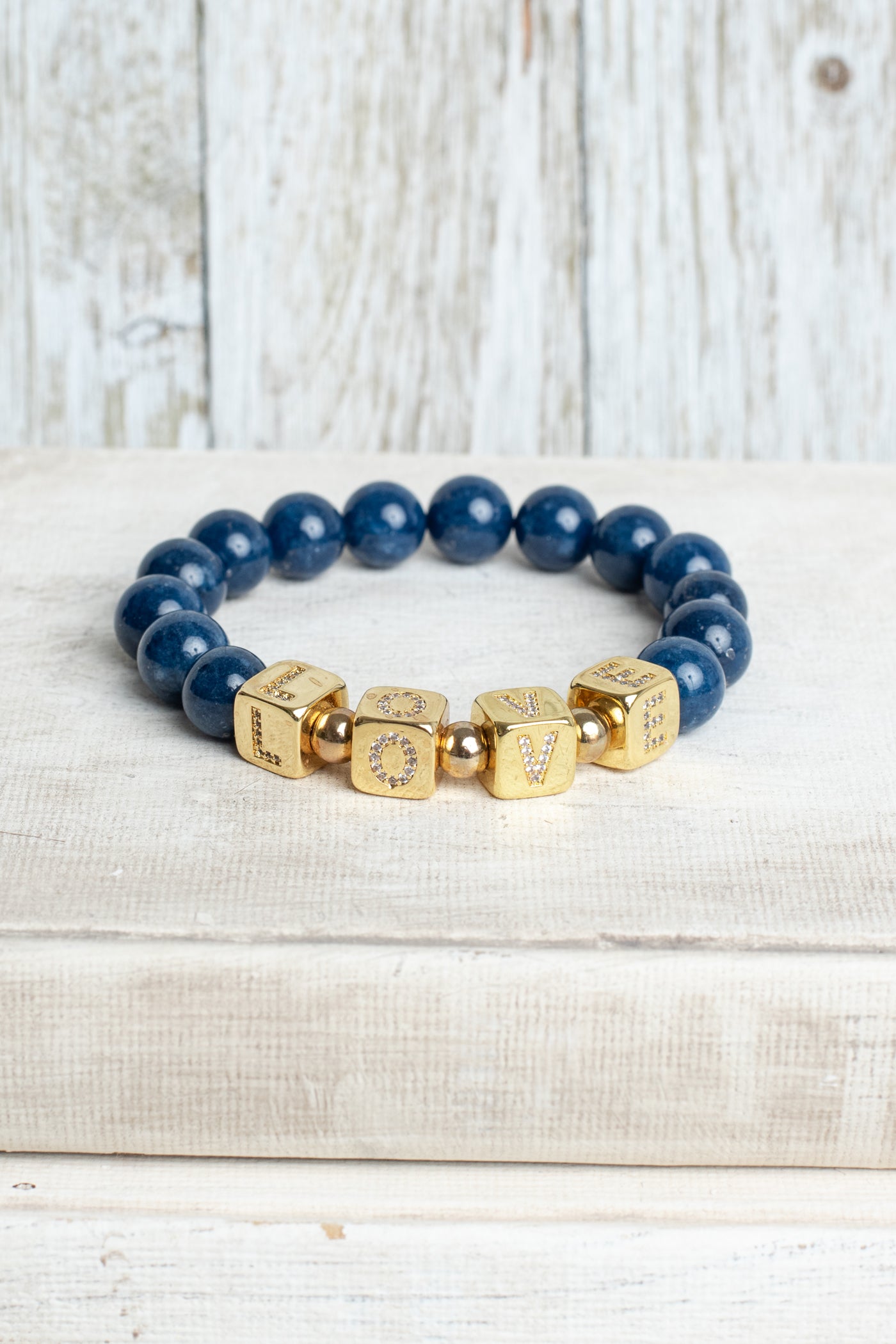 Striking Gold Plated Cube Beads with Pave Crystal Letters Spelling LOVE on Navy Blue Agate Stretch Bracelet